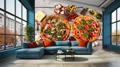 appetizing sliced pizzas, wooden background. Wall mural