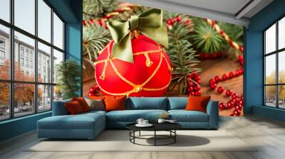 Beautiful red ball with a green bow. Wall mural