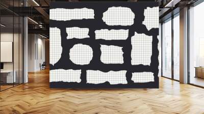 Torn grid paper sheets isolated on black background Wall mural