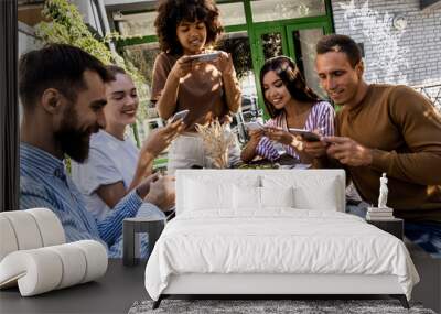 Friendship, leisure and technology concept - group of happy smiling friends with non alcoholic drinks photographing by vintage camera at picnic in summer park Wall mural