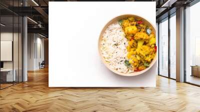 Indian kitchen. Gobi aloo cauliflower dish with rice in a bowl on a white background. Copy space Wall mural