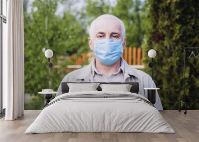 Man in medical mask in park. Protection from the illness. Health safety concept Wall mural