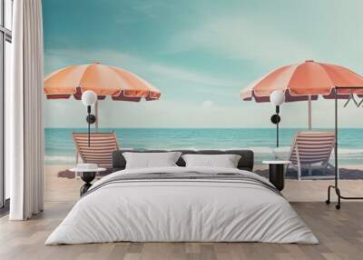 Two chairs and umbrellas on a beach near the ocean. Wall mural