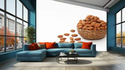 small grains of natural brown dried almonds in a decorative plate on a white background Wall mural