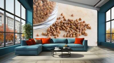 Buckwheat groats in a glass on a wooden table Wall mural