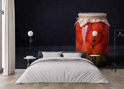 Fermented preserved vegetarian food concept. Pickled or salted canned tomatoes on dark background with copy space Wall mural