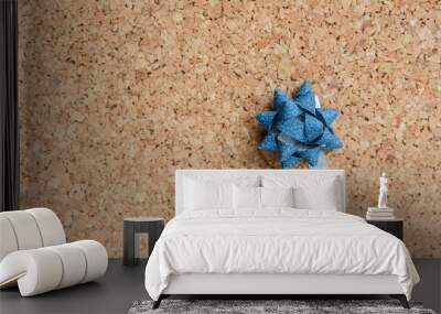 Glitter blue ornament on natur cork board  background. Wall mural