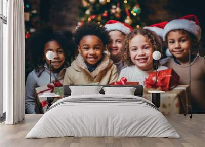 Group portrait of diverse kids with gift boxes during Christmas holidays looking at camera. Wall mural