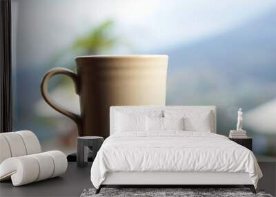 A cup of coffee on mountain. Empty cup of tea or coffee. Inspirational motivational backgrounds. Wall mural