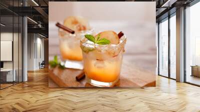 Apple cider cocktail with cinnamon and apple traditional autumn and winter drink Wall mural