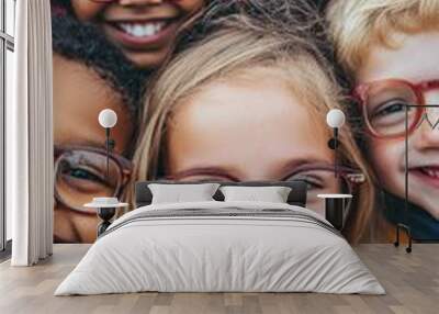 Diverse group of cheerful children wearing colorful glasses smile brightly at the camera, showcasing friendship and joy in a close-up portrait. Wall mural