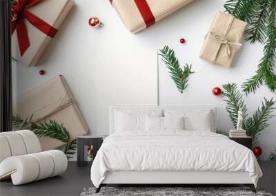 Festive Christmas flatlay with wrapped gifts, pine branches, and blank card for personalized message, perfect for holiday greetings or invitations.Copy space Wall mural