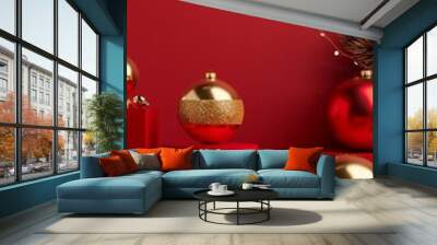 Festive red and gold Christmas ornaments arranged on geometric platforms against a vibrant crimson background, creating a luxurious holiday display. Wall mural