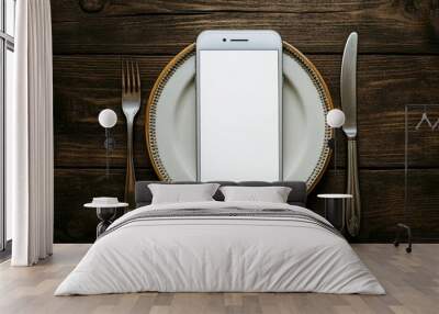 Modern dining meets digital age: sleek smartphone centered on elegant white plate, flanked by silver cutlery on rustic wooden table, blending tech with tradition. Wall mural