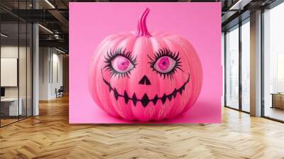 Whimsical pink Halloween pumpkin with exaggerated eyelashes and a mischievous grin, set against a vibrant pink background, blending spooky and cute aesthetics. Wall mural