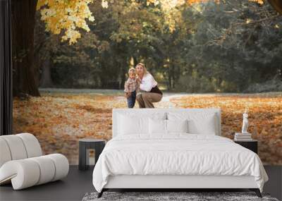 Mothers day, love family.  Family on autumn walk in nature outdoors. Mother and child with hugging tenderness Wall mural