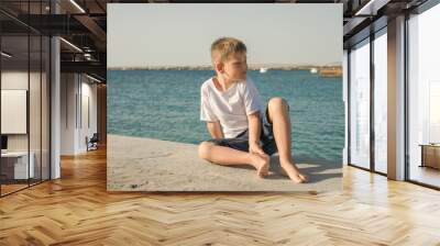 Portrait of happy child on the beach. Summer vacation concept. Smiling kid boy  near sea Wall mural