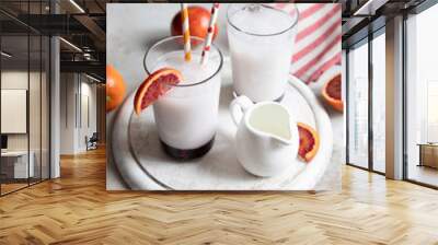 Two glasses of Italian soda with blood orange syrup, milk and ice. . Wall mural