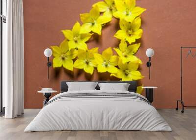 Number 4 of yellow flowers on brown background. Vertical photo Wall mural