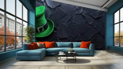 Saint patrick's day celebration with a green leprechaun hat and clover leaf on a black stone background. Copyspace. Wall mural