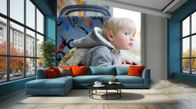 Toddler boy in train or tram Wall mural