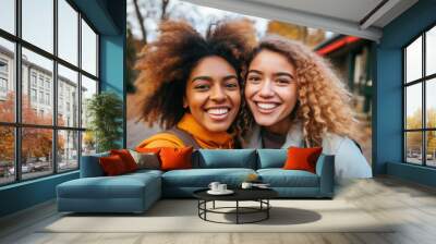 Selfie portrait of two young women smiling and looking at camera. Wall mural