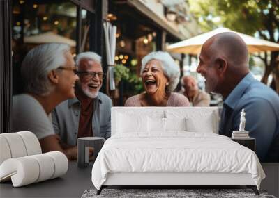 Small group of active seniors having fun together talking and laughing in cafe or restaurant. Wall mural