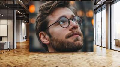 A man with a beard and glasses looking up Wall mural