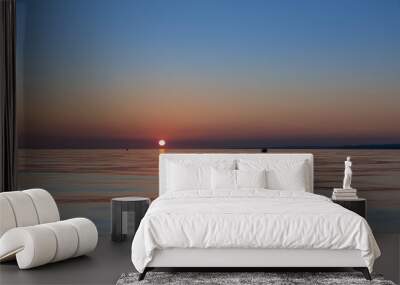 Sun going down in the ocean, soft colours sunset Wall mural