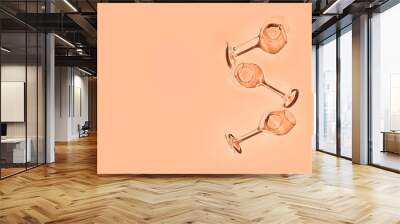 Glasses with wine or champaign on peach fuzz color background. Flat lay. Color of the year. High quality photo Wall mural