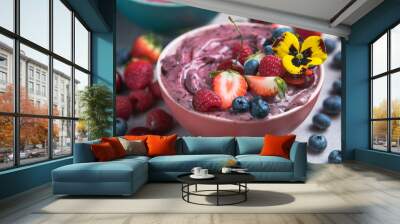 Two summer acai smoothie bowls with strawberries, blueberries,   on gray concrete background. Breakfast bowl with fruit and cereal, close-up, top view, healthy food Wall mural