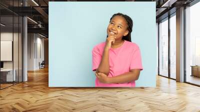 Beautiful smiling Nigerian girl with stylish hairstyle in casual clothes standing looking away Wall mural