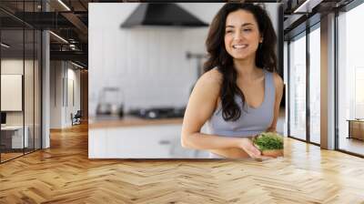 Beautiful smiling woman holding bowl with fresh micro green Wall mural