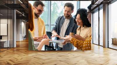 Group of diverse business people discussing charts with quartal sales growth in office interior Wall mural