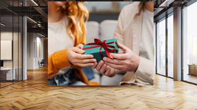 Man giving gift box for lovely woman, focus on hands. Romantic couple celebration birthday. Dating, love, Valentines day concept  Wall mural