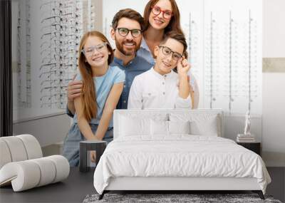 Portrait of young happy family wearing stylish eyeglasses sitting in  optical store. Vision concept  Wall mural