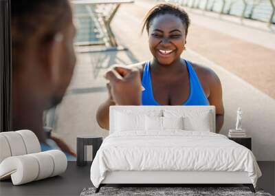 Positive african american couple talking after working out outdoors. Training, healthy lifestyle Wall mural