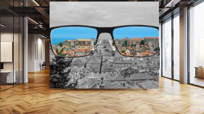 Different perception of world. Colorful view of red roods and blue sea in  Looking through glasses. Wall mural