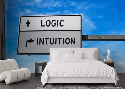 Logic versus intuition. White two street signs with arrow on metal pole. Directional road. Crossroads Road Sign, Two Arrow. Blue sky background. Wall mural