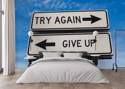 Try again vs give up. White two street signs with arrow on metal pole with word. Directional road. Crossroads Road Sign, Two Arrow. Blue sky background. Two way road sign with text. Wall mural