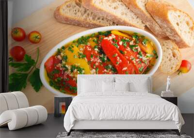 red and yellow marinated bell peppers in serving dish, garnished with bread and decorated with parsley and cherry tomatoes Wall mural