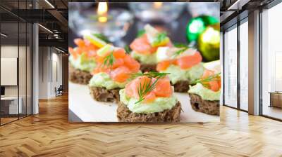 Appetizer canapes of bread with avocado, red fish salmon, lemon, Wall mural