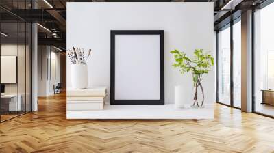 Home interior with decor elements. Mockup with a black frame, spring flowers in a vase on a light background Wall mural