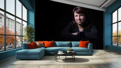 Young caucasian woman portrait on black background in studio Wall mural