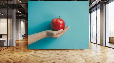 hand holding red apple Wall mural