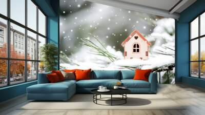 Christmas toy house on a natural natural background of a real fir in the snow, toned. Concept of winter, Christmas, new year Wall mural