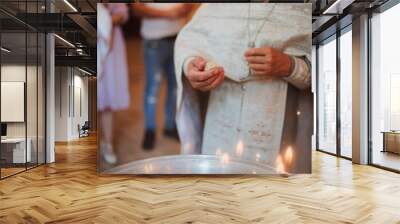 baptism of a child in the church, preparation of the ceremony, cross, holy water Wall mural