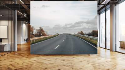 Road that goes up over a hill Wall mural