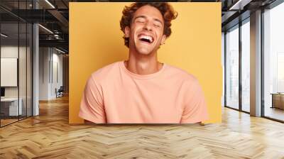 Young adult man laughing agaisnt solid color background.  Image generative AI. Wall mural