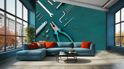 Set of professional tools for renovation or home repairs on the green wooden background. Copy space Wall mural